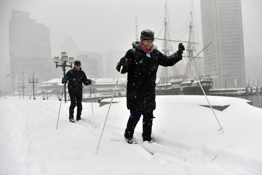 Erica Sibinga and her husband, Ken Hilker, take a tour around Baltimore's Inner Harbor on cross country skis on Saturday, Jan. 23, 2016, during a powerful weekend storm blanketing the East Coast in snow.