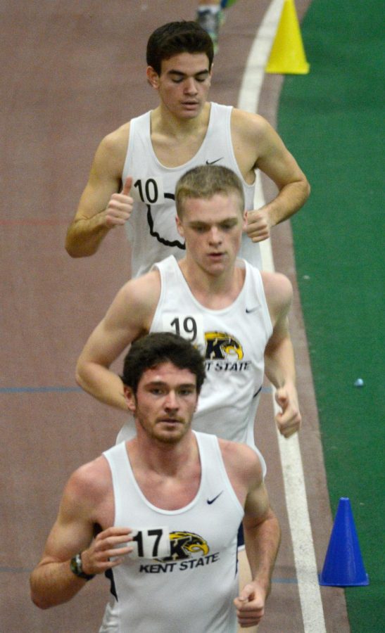 Kent State track and field team members run the 5000 meters event at the dual-open Doug Raymond Invitational Saturday, Jan. 11, 2014 in the field house.