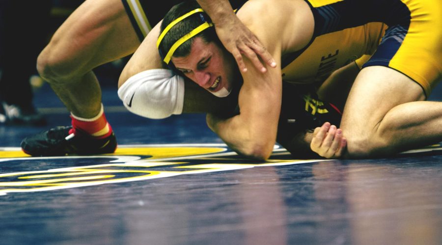 5th-year Senior Tyler Buckwalter works for a single leg takedown against Daniel Lewis of the University of Missouri at the MAC Center on Dec. 20, 2016. The Golden Flashes lost to Missouri 12-35.