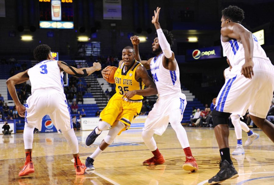 Redshirt junior Jimmy Hall drives the lane surrounded by defenders from University at Buffalo at Alumni Arena on Tuesday, Feb. 23, 2016. Buffalo beat Kent 87-70.