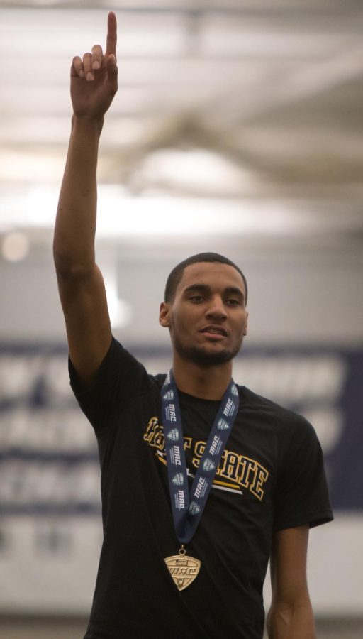 Senior Roosevelt Dotson raises his finger after receiving his first place medal in the high jump competition during the MAC Indoor Track and Field Championship at University of Akron's Stile Athletic Field House on Saturday, Feb. 27, 2016.