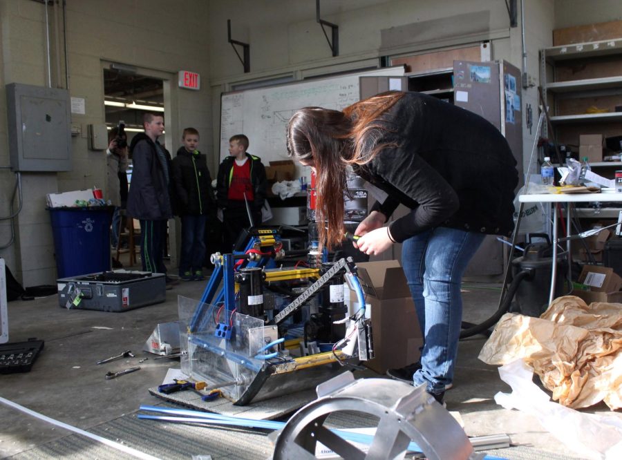 Sophomore Kent robotics team member Sarah Rosenbaum adds some final touches to her team’s robot before the practice competition on Saturday, Feb. 6, 2016. The team competed against Virginia Tech, Akron University and Iowa State in a practice round before the final competition in May.