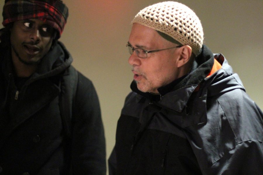 Dr. Julio Pino speaks with senior history major Elijah Ali after leaving class Thursday, Jan. 21, 2015.