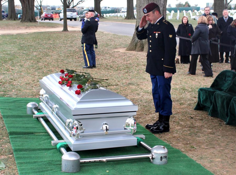 Kent State student Josh Kocsis salutes his grandfather’s casket as a final goodbye. “He may not be here on Earth, but he is flying planes still where he rests, just happy as can be,” Kocsis said.