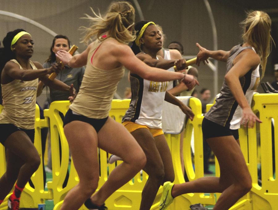 Junior Jordin Ordway hands off the baton to junior Chelsea Laury in the 400 meter relay at the Kent Fieldhouse on Friday, Jan. 22, 2016. Kent lost the meet to Akron, 80-71.