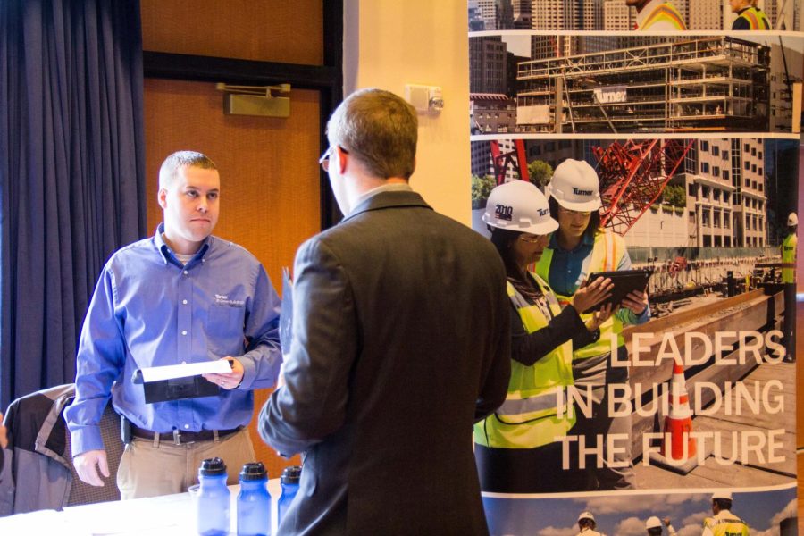 Bill Stiffler of Turner Construction Company talks with a student during the Construction Management Career Fair on Friday, Feb. 12, 2016. Over the course of a semester, the fair has doubled in the number of companies.