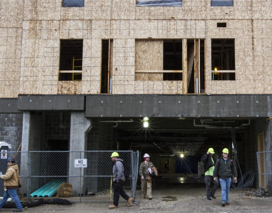 Construction workers leave the site of the 345 Flats on the corner of Summit and Depeyster Street on Wednesday, Feb. 24, 2016.