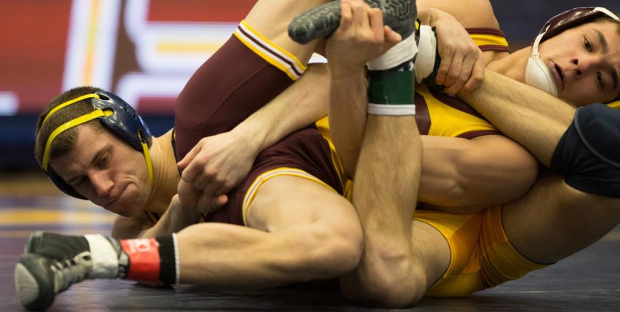 Fifth year senior Tyler Buckwalter wrestles Jordan Atienza of CMU in the MACC on Sunday Feb. 14, 2016. Buckwalter won 11-9. Kent beat CMU 18-17.