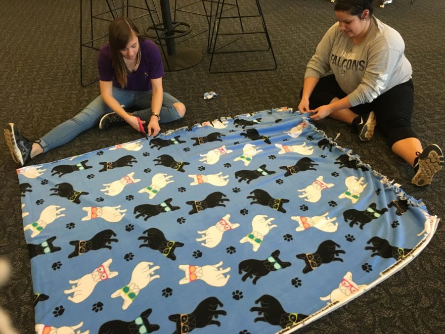 Student volunteers work on blankets at Eastway Center on Tuesday, March 8, 2016.