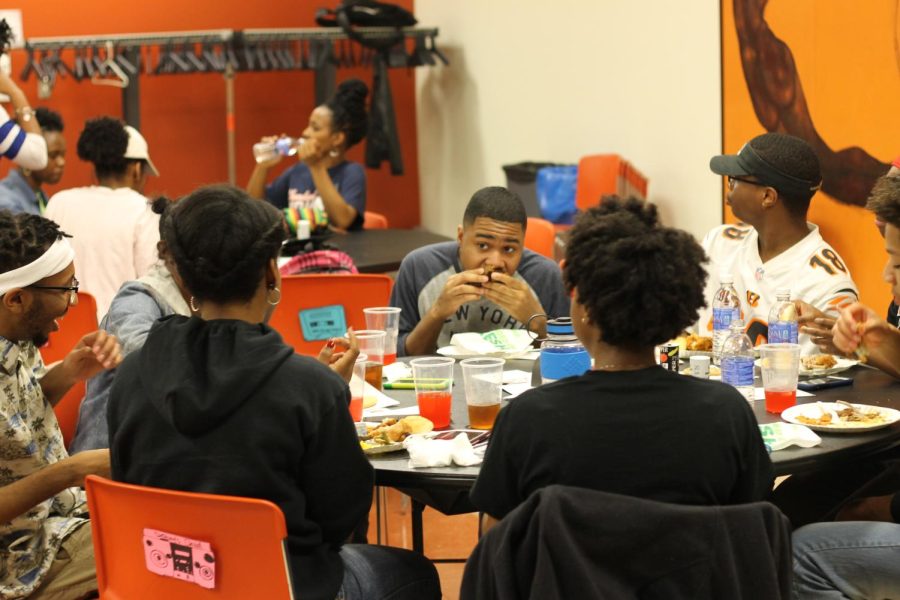 Students gather around at the "Cincinnati" table during the "Rep Your City" BUS Community Dinner March 14.