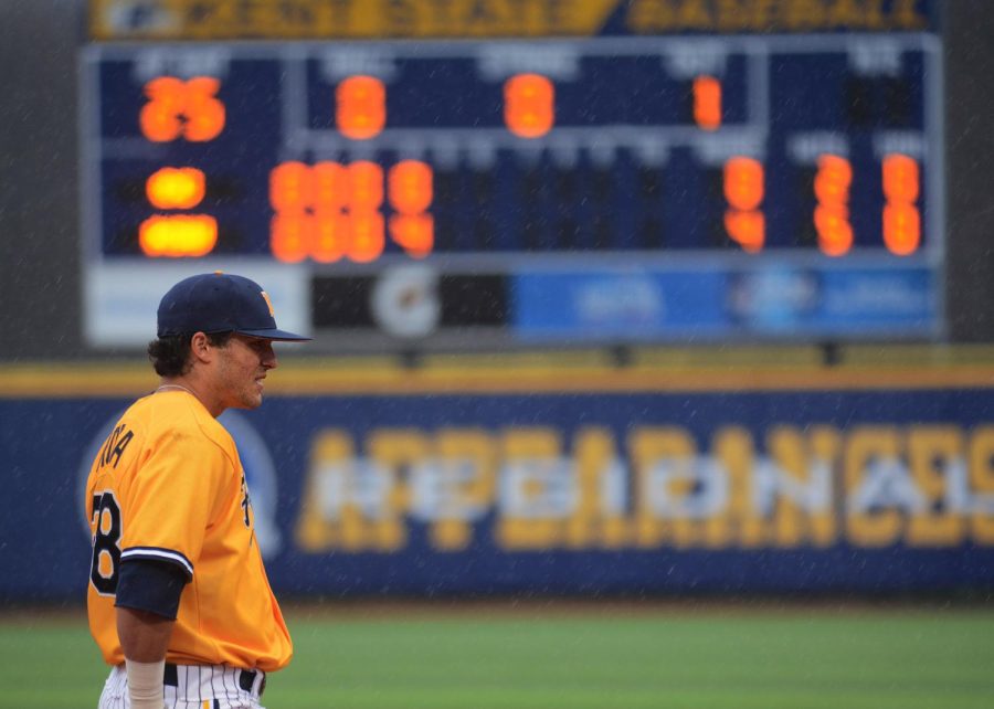 Sophomore infielder Dylan Rosa waits for the pitch in the pouring rain a game against Canisius College on Wednesday, April 6, 2016. After a delay due to lightning, the Flashes lost to Canisius 5-4.