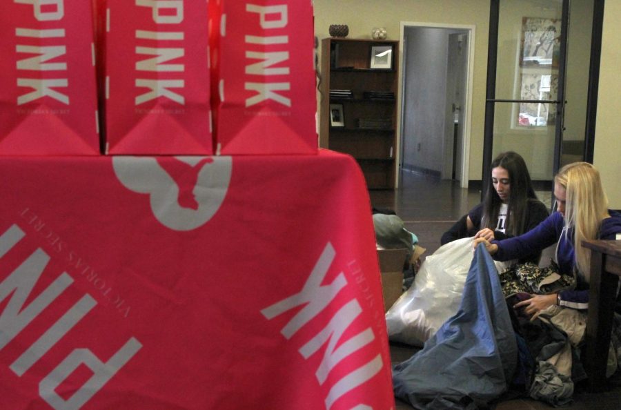 Sam Arslanian (left) and Juli Houck, campus representatives for Victoria's Secret, sort through donations for the PINK Gimme Good Vibes Initiative in University Oak's Clubhouse on Wednesday, April 13, 2016.