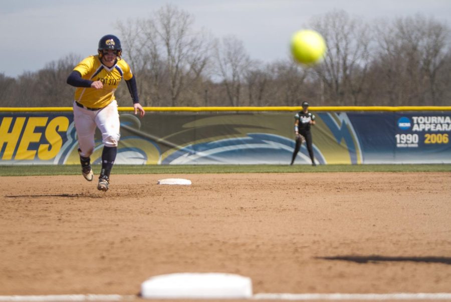 Junior infielder Maddy Grimm races towards third base as the ball flies foul at the Diamond at Dix Stadium on Wednesday, April 13, 2016. Kent State defeated Ohio University, 5-4, in 2 extra innings.