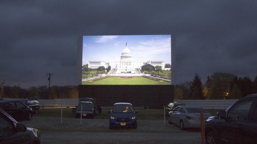 A woman sits in her car while the national anthem plays on the screen at the Midway Drive In on Friday April 29, 2016. While drive ins may seem like a thing of the past, those still open are thriving.