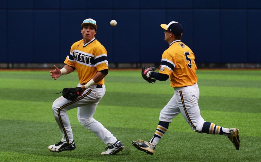 Sophomore infielder Dylan Rosa, left, and junior infielder Sam Hurt, right, chase after a bouncing ball in the game versus Western Michigan University on Saturday, April 2, 2016. The Flashes won 9-7.