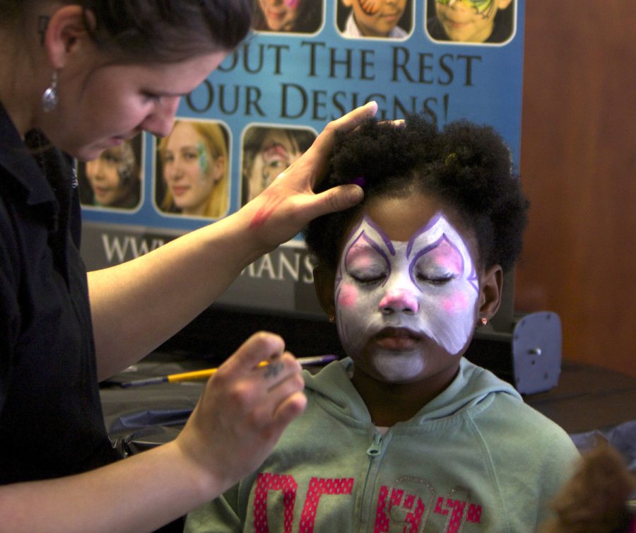 Raychelle Richardson has her face painted in the Tri-Towers Rotunda during the 'Sibs and Kids Weekend' on Saturday, April 9, 2016.