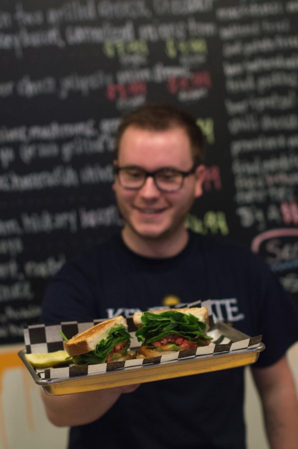 Twisted Meltz manager Mike Canter holds out the sandwich shop’s signature “Julian Edelman” sandwich.