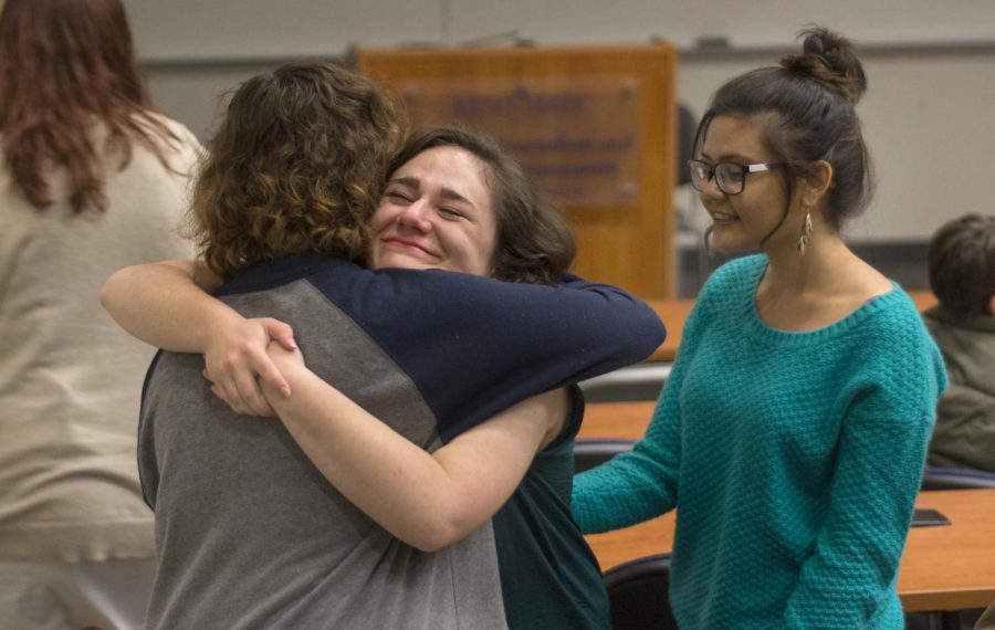 Sophomore journalism major Carrie George embraces freshman journalism major Logan Lutton during the presentation of their multimedia projects about grandparents on Thursday, April, 21, 2016.