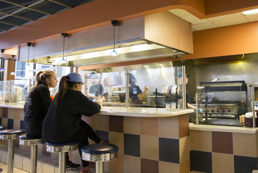 Students sit at the counter of Rosie’s Diner and Market in the Tri-Towers Rotunda on Sunday, April 10, 2016.