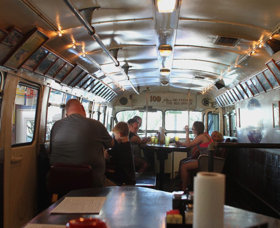 Diners eat lunch in a retrofitted bus inside Mike's Place on Saturday, April 16, 2016.