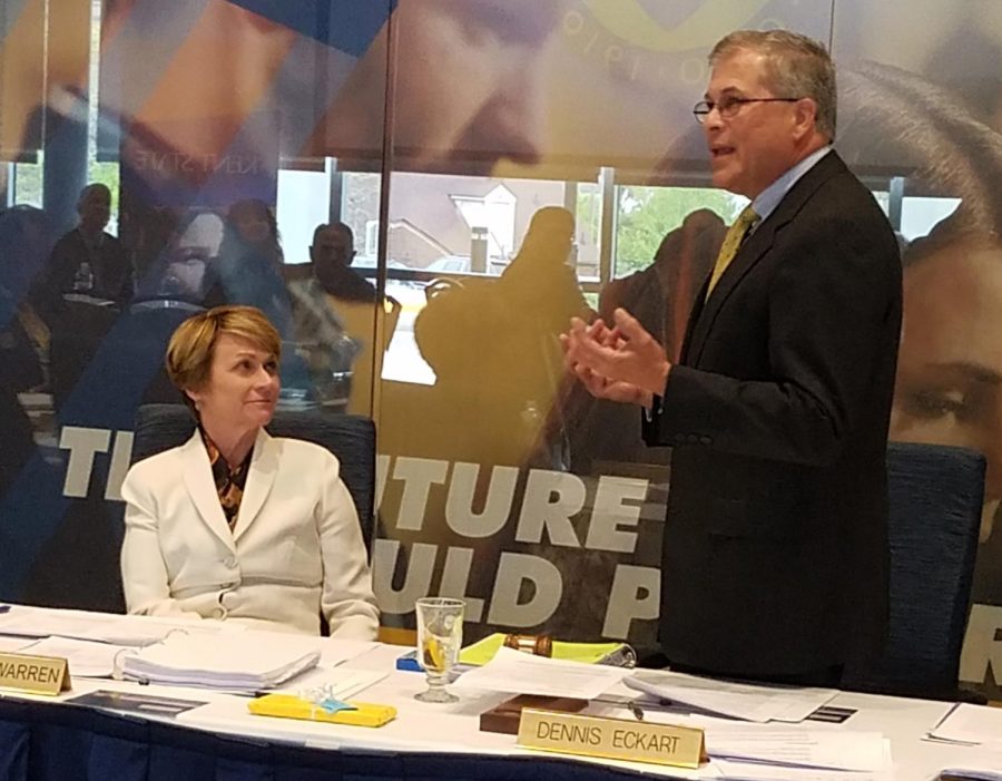 Kent State’s Board of Trustees’ Chairman Dennis Eckart congratulates President Beverly Warren on her three-year contact renewal during the May 11 board meeting.