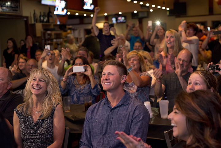 Kent State's Eric Lauer , his mother, Carole, left and his sister and girlfriend and large crowd of excited supporters react after Lauer is chosen 25th overall in the first round of the MLB draft by the SanDiego Padres. The draft party was held at Aces bar and grill in North Ridgeville, Ohio, on Thursday, June 9, 2016.