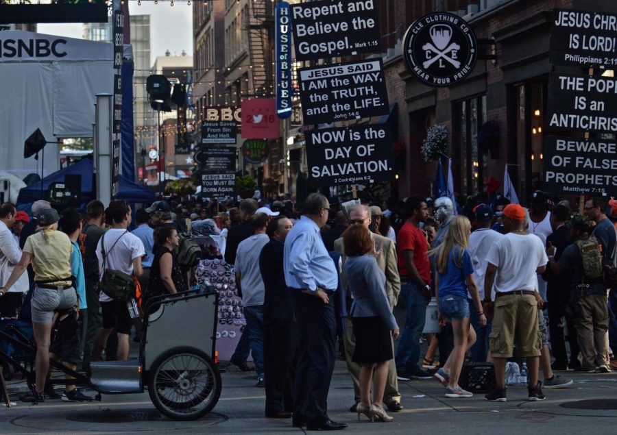 Residents and visitors of downtown Cleveland's E. 4th Street take part in the evening events during the first day of the Republican National Convention on Monday, July 18, 2016. 