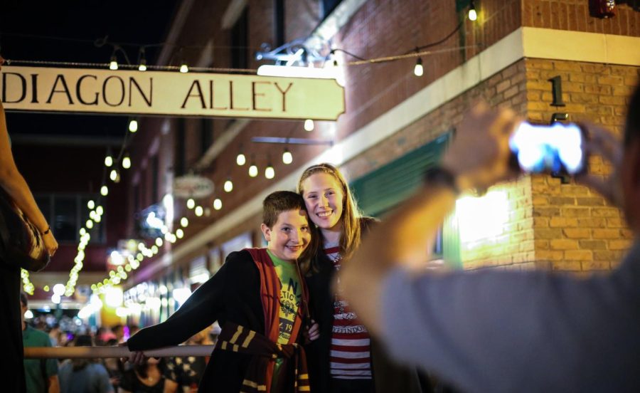 Shamus Clavin,10, and Hannah Clavin,16, pose for a picture outside of Diagon Alley during the Kent Potterfest in downtown Kent on Saturday, July 30, 2016.