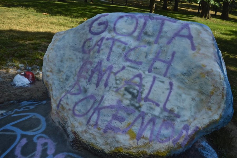 The Rock on Kent State's main campus sits spray painted with the Pokemon tag line "gotta catch 'em all" on its surface on Wednesday, July 13, 2016. 