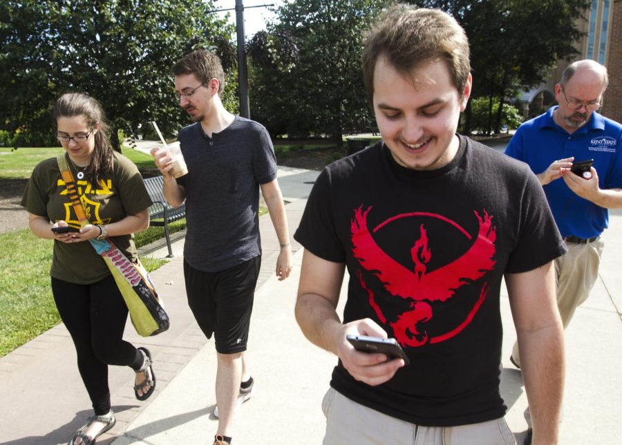 (From left to right) Senior fine arts major Melissa Mendelson, Kent State Pokemon League director of tournaments Patrick Brett, junior computer sciences major Max Eisenloeffel and Kent State employee Gaylen Moore tour the main campus playing "Pokemon Go" on Thursday, Aug. 25, 2016.