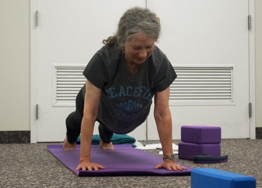 Professor Mary Louise Holly performs her yoga routine at the Williamson Alumni Center Wednesday, Sept. 14, 2016.