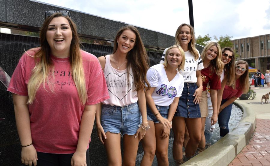 Members of the sorority Alpha Phi pose standing in the Kent State fountain in Risman Plaza during the Black Squirrel Festival on Friday, Sept 9, 2016.