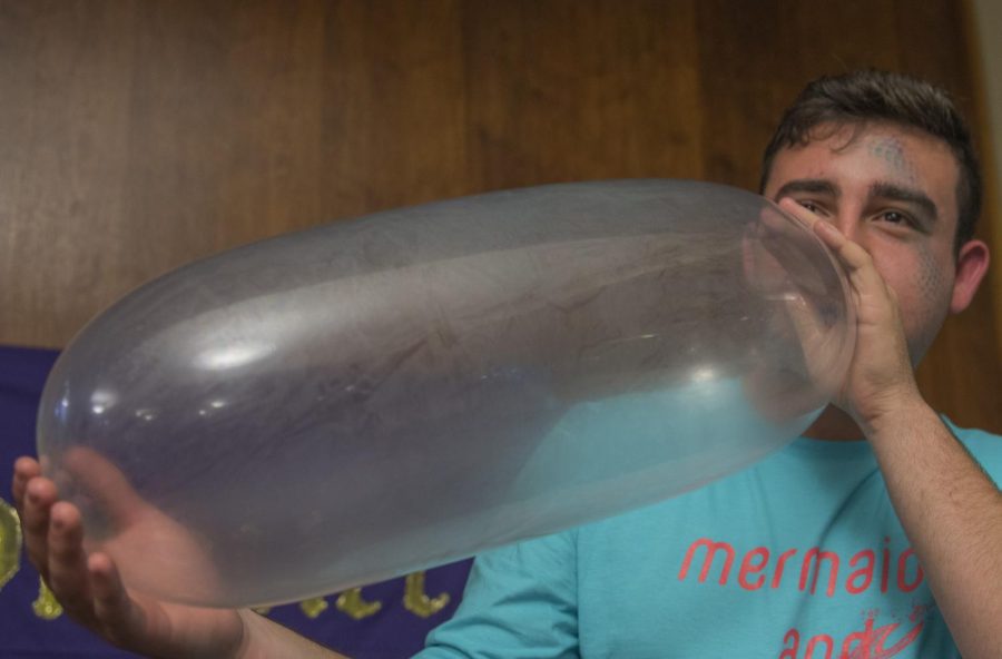 John Young is a freshman entrepreneurship major staffing the condom popping activity at Sextoberfest in Tri-Towers Rotunda on Friday Oct. 21, 2016.