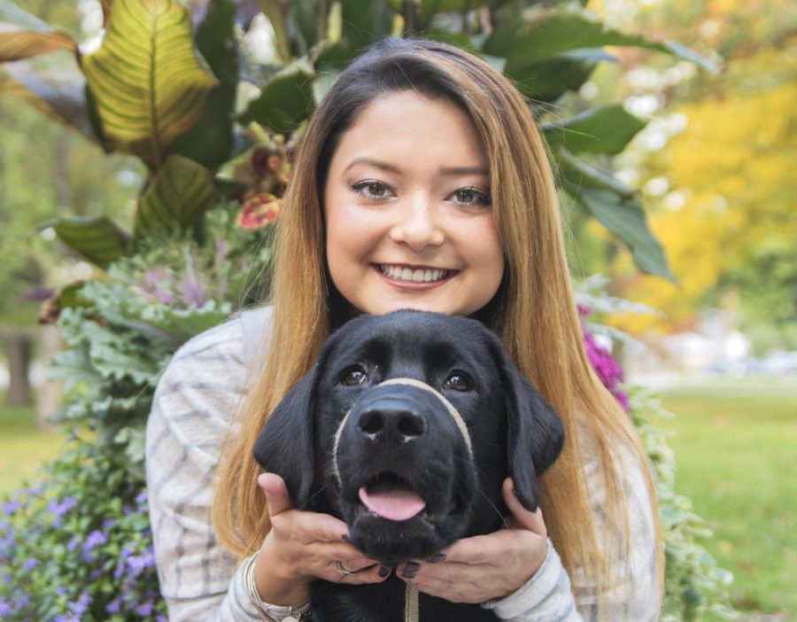 Anna Dempsey, a senior double major in criminology and justice studies and sociology, with Sully, a service dog, on Wednesday Oct. 19, 2016.