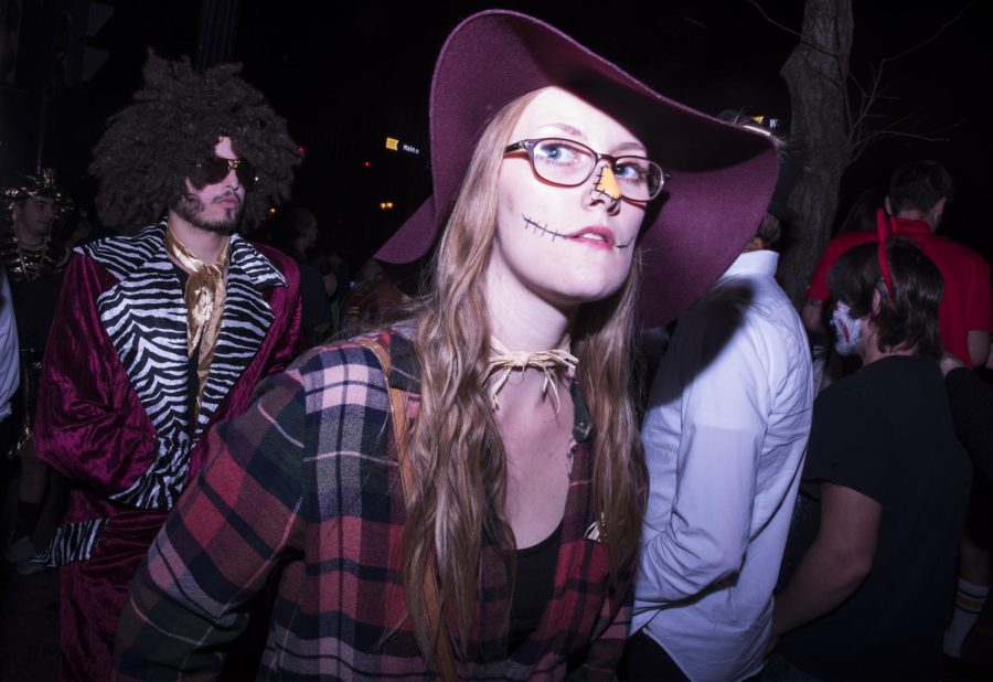 Kent State senior anthropology major Kayla Metzger walks through downtown Kent in her scarecrow costume during Kent Halloween on Saturday, Oct. 29, 2016.