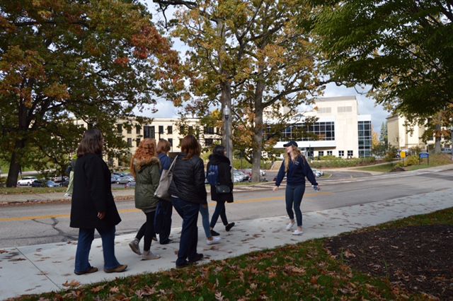 Senior fashion merchandising major Megan Fishburn gives prospective Kent State students and their families a tour of the university's main campus.