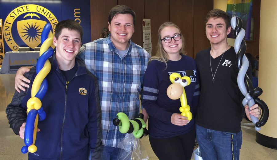 Junior communication studies major Nicholas Peters, senior aeronautics major Dylan Oliver, junior biology major Olivia Mullen, and senior biology major Troy Kotsch show their balloon sculptures at the Kent State Financial Aid Fair on Tuesday, Nov. 15, 2016.