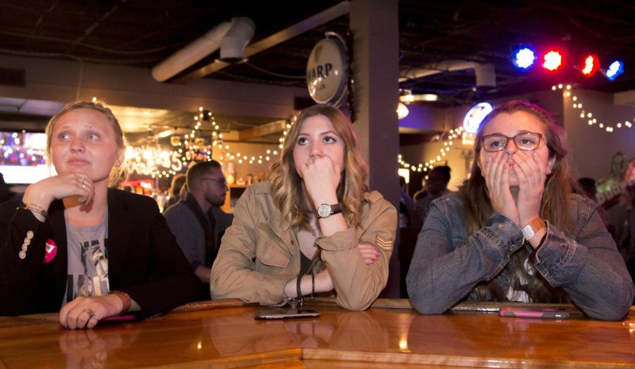 College Democratic Political Director Claire Goebel and her friends Madison Rowland, a fashion merchandise major, and Samantha Scozzaro, an education major, react to Donald Trump’s escalating electoral votes on election night Nov. 8, 2016 at Brewhouse in Kent. 