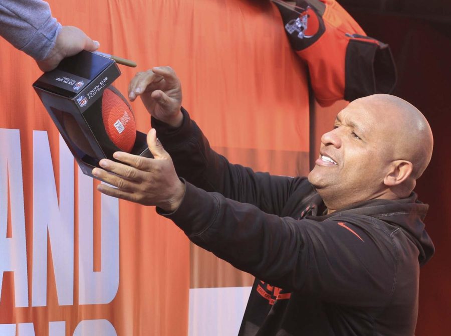 Cleveland Browns head coach Hugh Jackson signs a autograph for a young fan before the game against the New York Giants on Sunday, Nov. 27, 2016 in Cleveland, Ohio, at FirstEnergy Stadium.