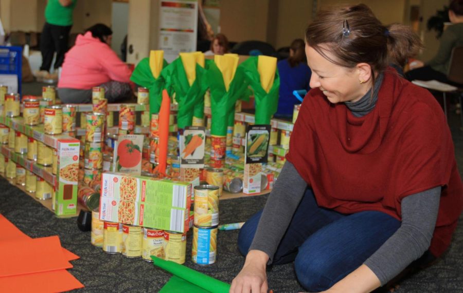 Kent State grad appointee Lyn Haselton works on the can sculpture being created by the College of Public Health in the Eastway Center on Thursday, Nov. 17, 2016.