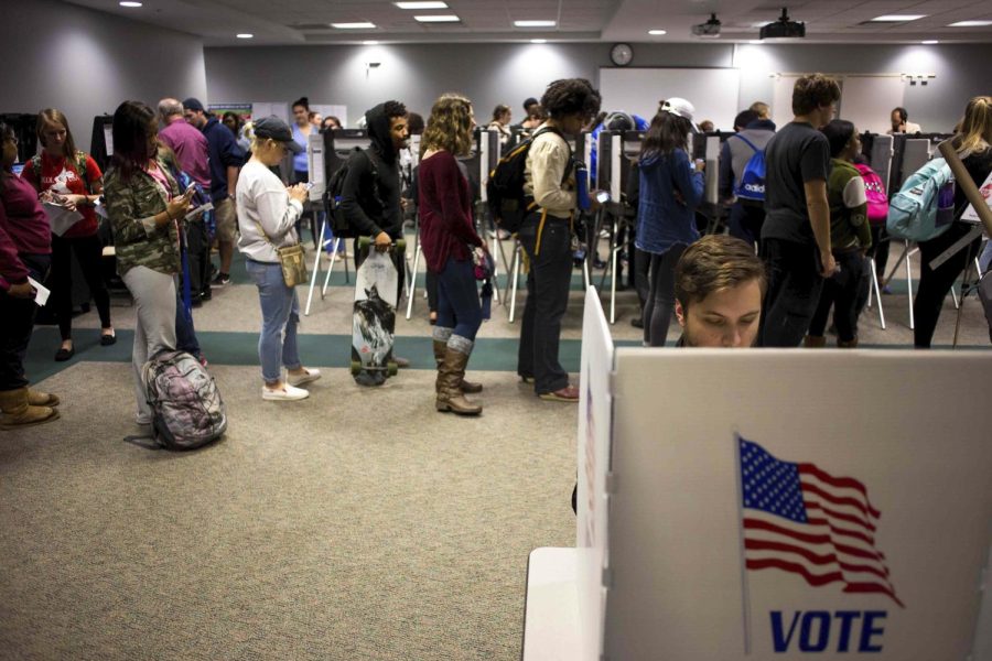 Jack Kenyon, a senior digital science major, casts his vote for the election on Tuesday, Nov. 8, 2016 as others wait in line at the Kent State's Student Recreational and Wellness Center.