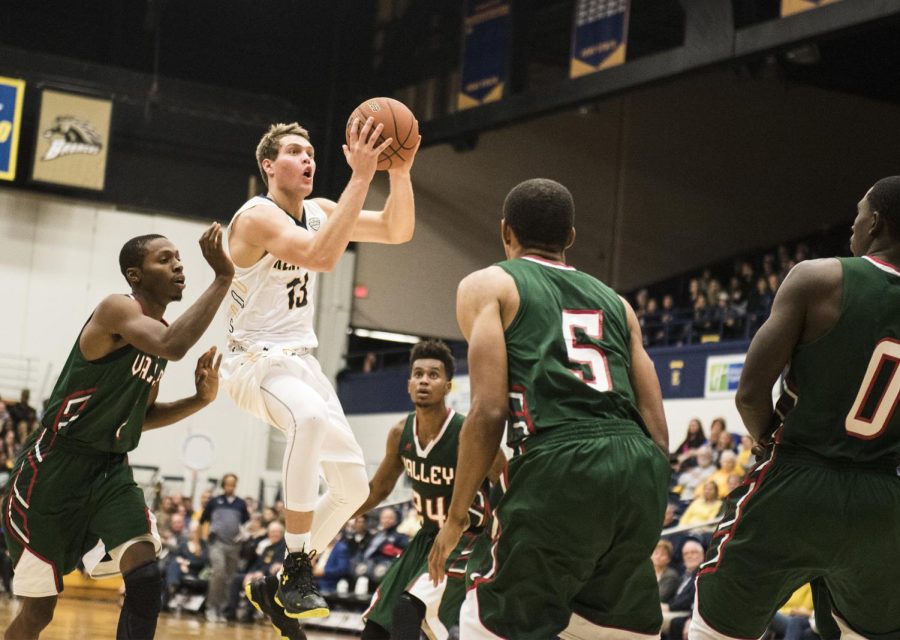 Freshman guard Mitch Peterson of the Kent State men's basketball team jumps through the Mississippi Valley State University defense on Wednesday, Nov. 16, 2016 at the M.A.C. Center.