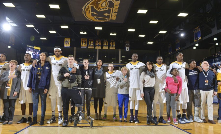 Members of the Kent State men's basketball team and members of the crowd stand for the national anthem before the team's home opener against Mississippi Valley State University on Wednesday, Nov. 16, 2016. The team invited members of the crowd of a different race on to the floor as a sign of unity.