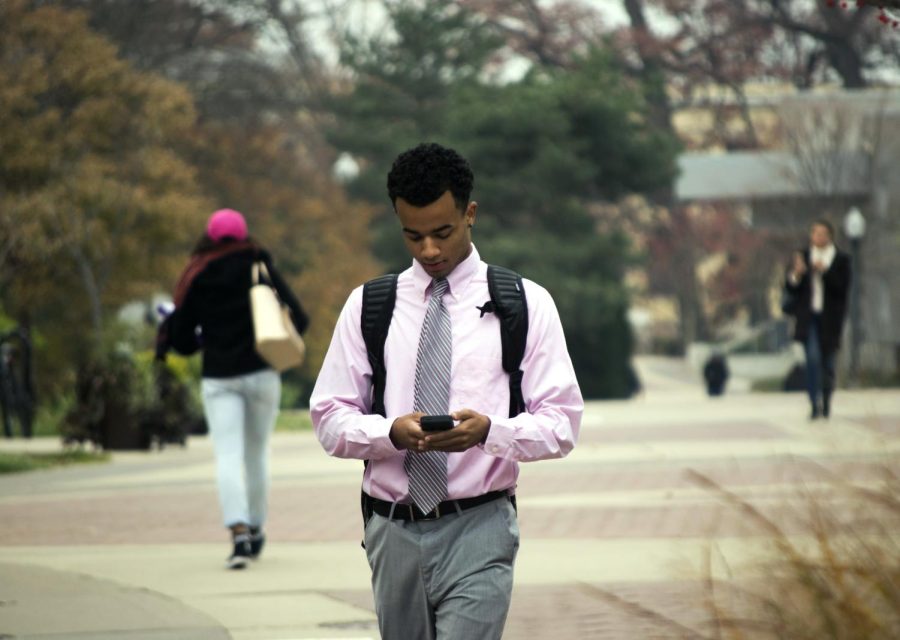 Marcus Summerlin, a sophomore philosophy major, walks down the Kent State Esplanade in Kent, Ohio, on Wednesday, Nov 16, 2016.