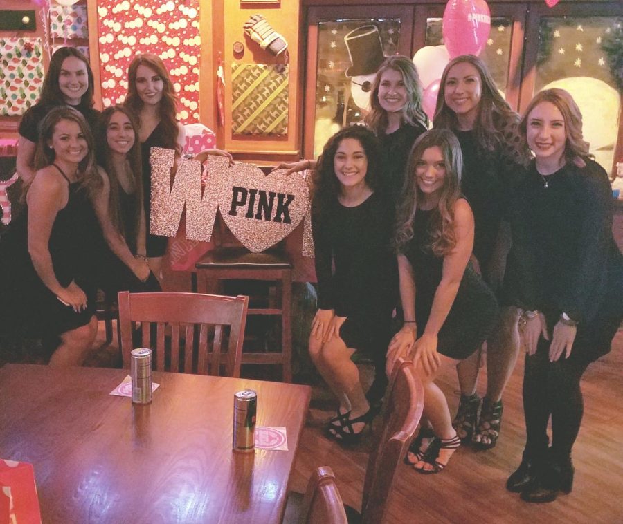 Members of Kent State PINK pose around their display at a Victoria's Secret Fashion Show viewing party at Panini's in Kent on Monday, Dec. 5, 2016. 