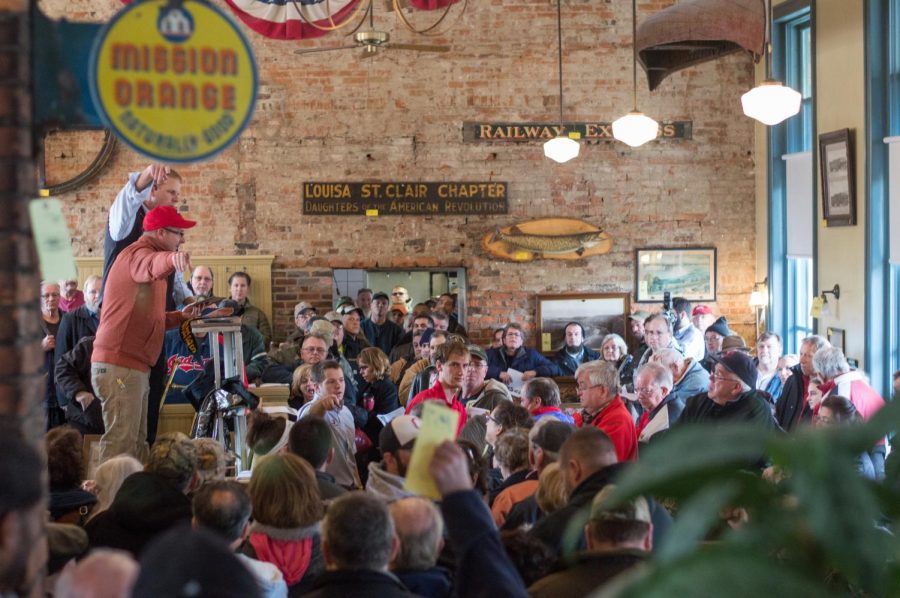 Bidders gather in downtown Kent's Pufferbelly LTD Restaurant on Franklin Avenue for an auction of more than 160 items of varying historical significance to the now-closed establishment on Wednesday, Jan. 4, 2016. 