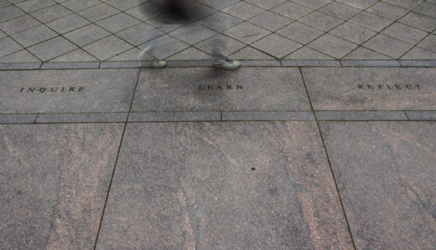 A student passes through the Kent State May 4 Memorial on the evening of May 3, 2016.