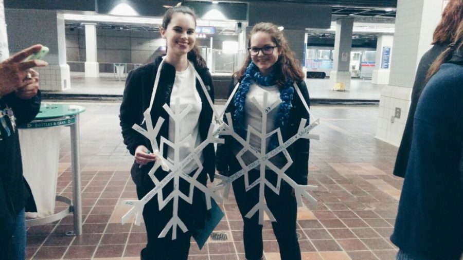 Kent State senior digital media production major Erica Collins and junior psychology major Kelsy Henderson wait for a train at the Public Square Station in Cleveland, Ohio on Saturday, Jan. 21, 2017.