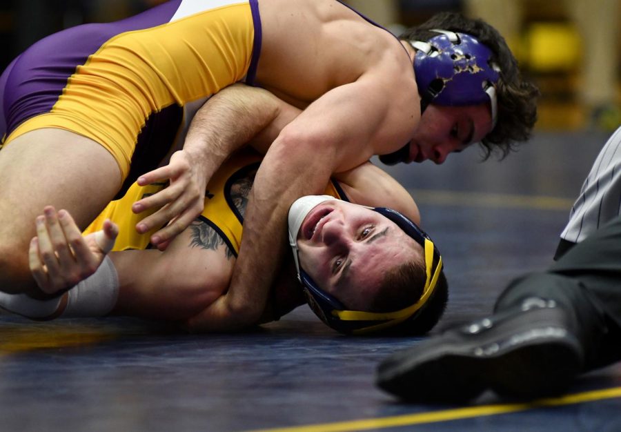 Kent State sophomore Isaac Bast fights against Northern Illinois sophomore Bryce Steiert at the M.A.C. Center on Jan. 29, 2017. Kent State lost 16-31.