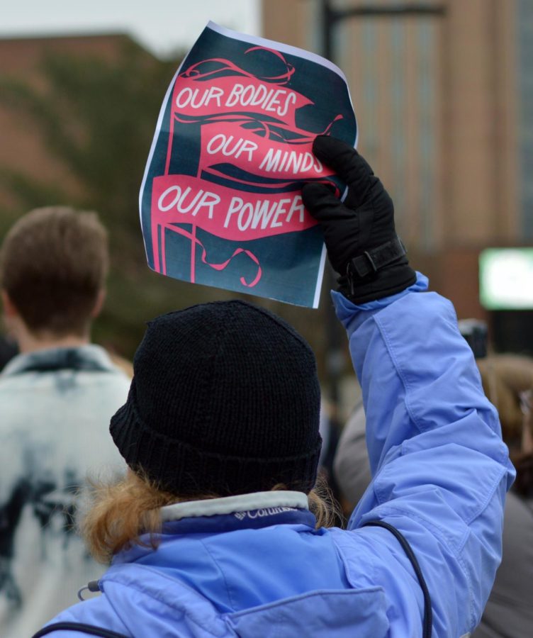 Diane Feagain holds a sign at the protest against Trump’s inauguration in front of the MAC Center on January 20, 2017.